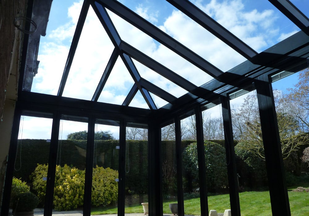 Hipped glass roof with bifold doors below