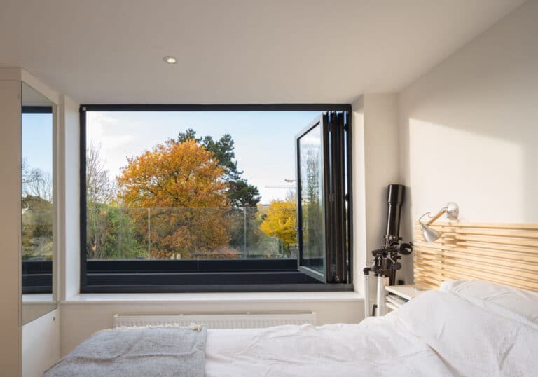 This three panel bifold window open out from this master-bedroom in a loft conversion