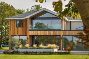 IDSystems theEDGE2.0 sliding doors - The master bedroom of this countryside home features a 3-panel set of doors with gable end glass above leading out on to a large balcony