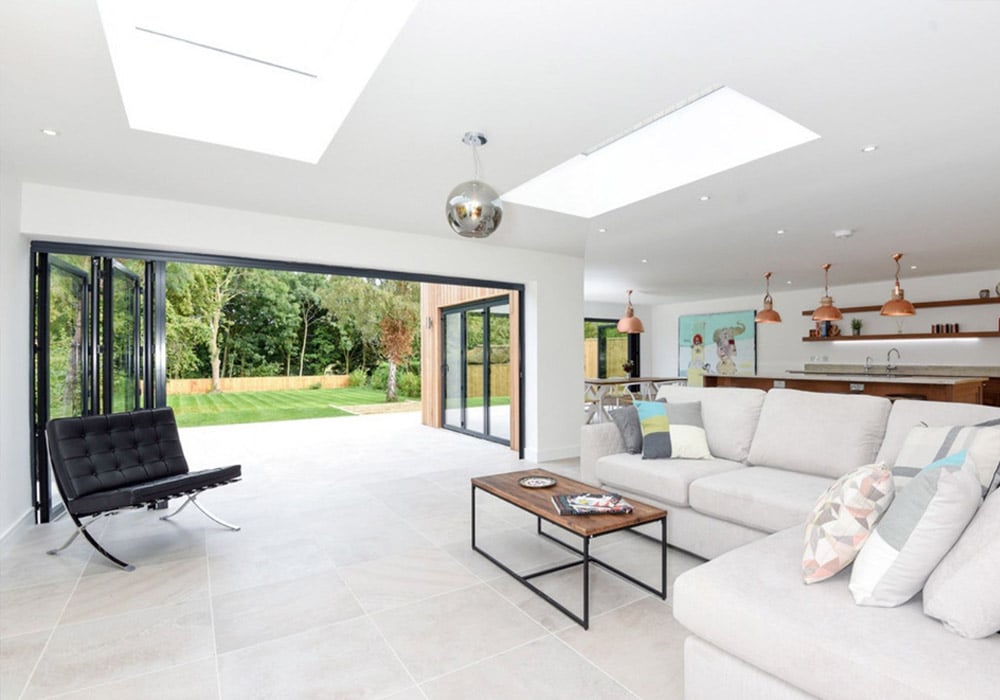 This large open plan living space and kitchen is connected with the patio thanks to three sets of SF55 bifold doors