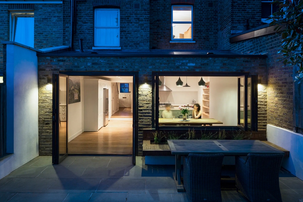 The kitchen of this North London extension extends out into the garden thanks to the bifold windows and doors, creating a stylish entertaining space