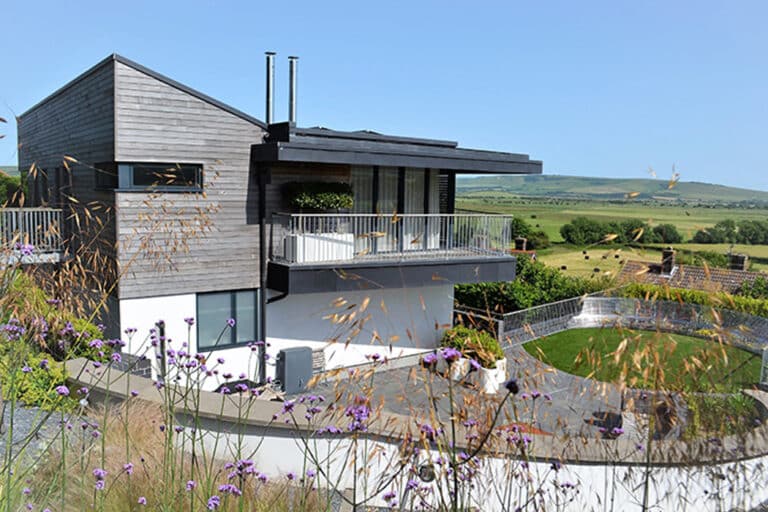 The corner-opening SF55 bifold doors provide stunning views over the rolling South Downs