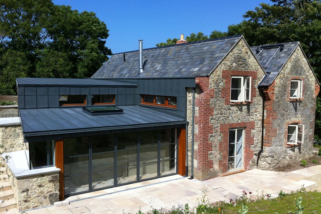This 19th Century stone cottage has been transformed with a modern extensuin including a 5-panel set of Heritage bifold doors