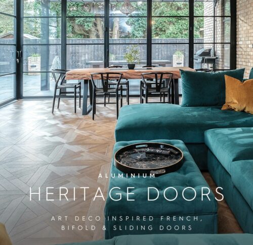 This living room, featuring aluminium heritage doors, boasts large glass sliding doors paired with a teal sectional sofa and round coffee table. The wooden dining set complements the style. Text overlay: "Art Deco Inspired French, Bifold & Sliding Doors." Explore more with our downloads.