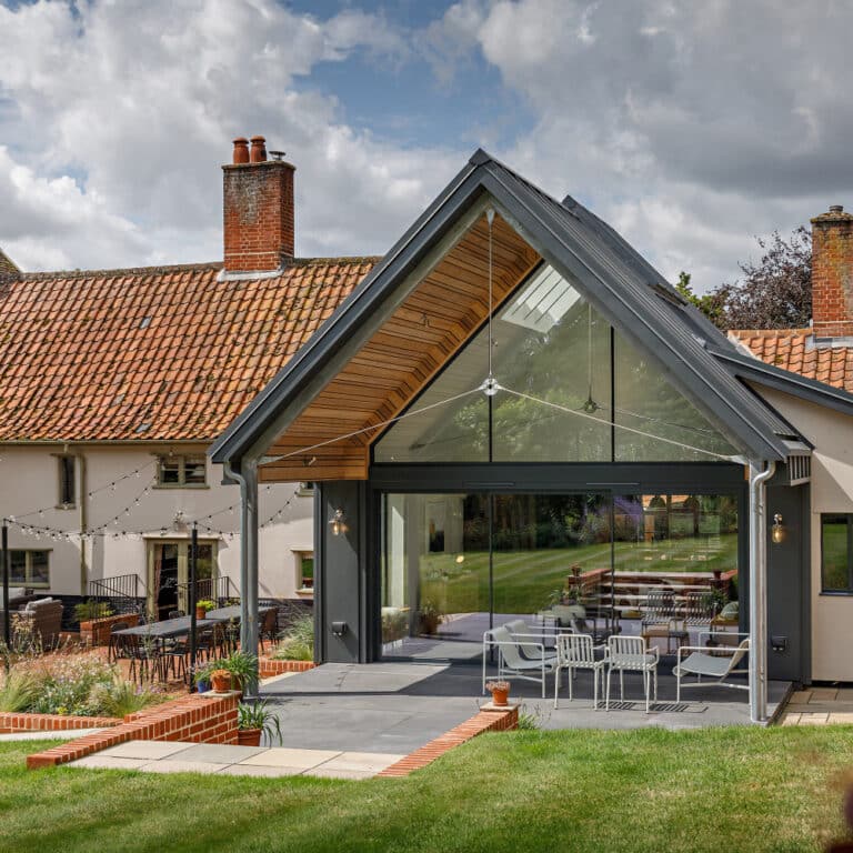 Period timber framed house with modern zinc clad extension featuring theEDGE2.0 sliding doors