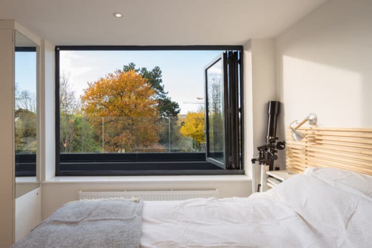 A stylish bifold window design completely opens up the view of the Cambridge skyline