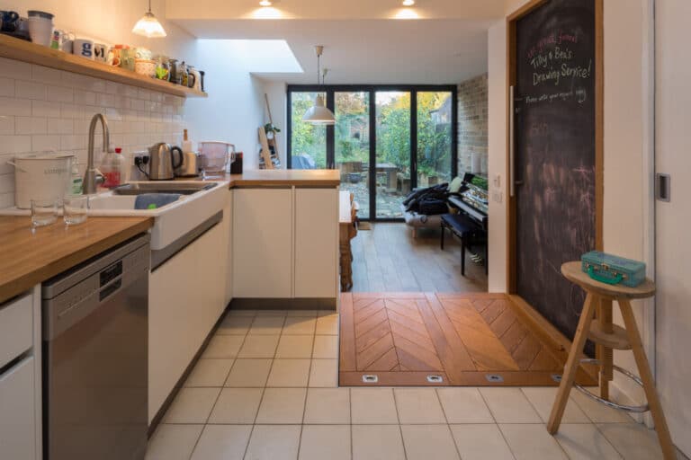 A terraced house's kitchen has been transformed by this extension complete with bifold doors across the rear