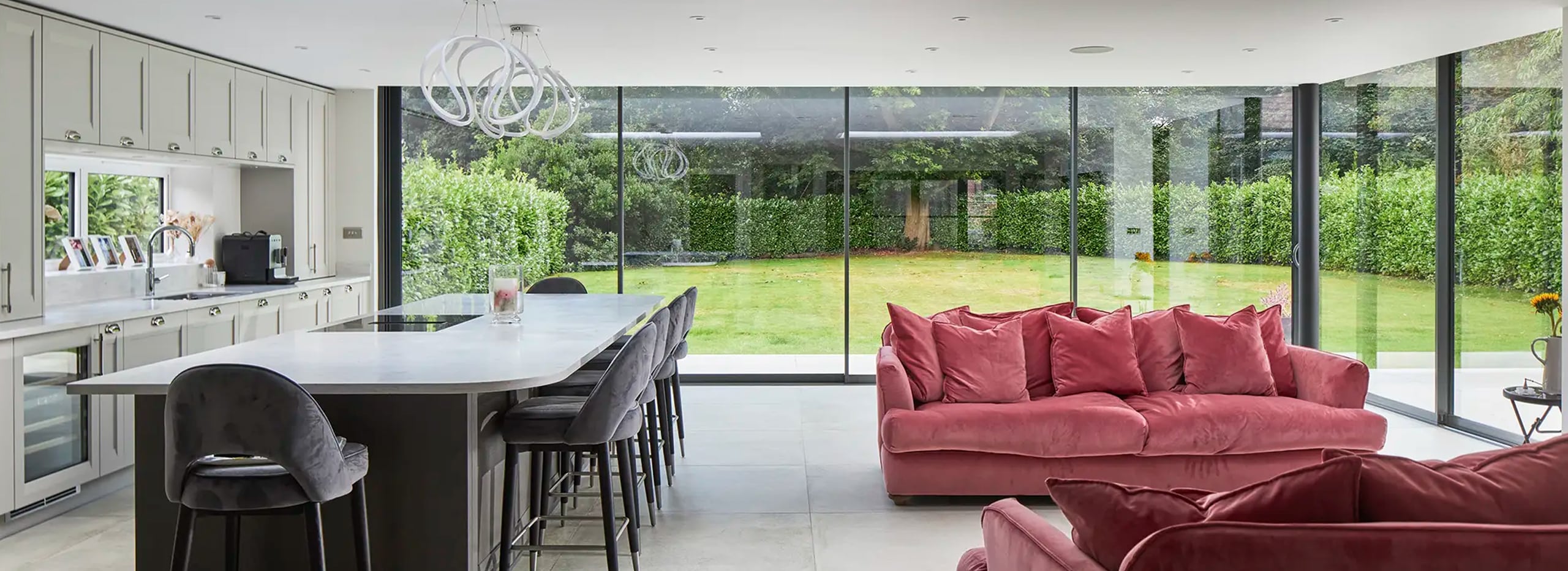 Stylish kitchen with theEDGE20 ultra-slim sliding doors providing a view out into the garden