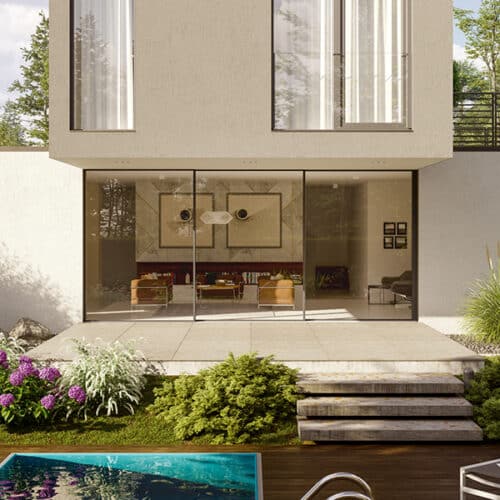 Modern house with expansive glass sliding doors, a patio, steps leading to a swimming pool, and a landscaped garden filled with flowers and shrubs in the foreground.